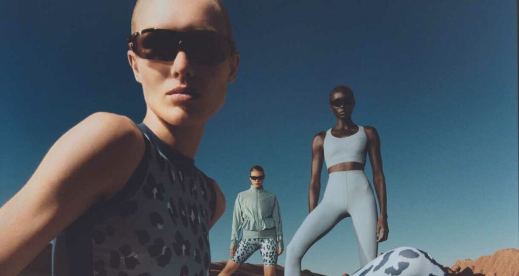 three women stand at different positions in the frame wearing activewear