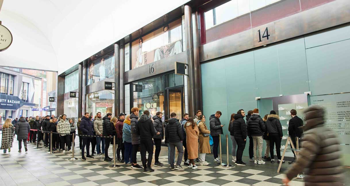 A shopping arcade showing a line of people waiting to visit the exclusive ARNE pop-up